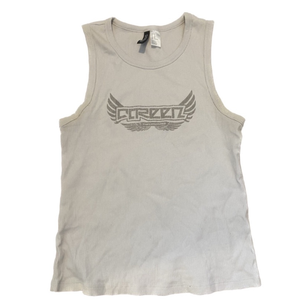 cream white top and it’s long so it hugs your torso right, goes perf w low rise.